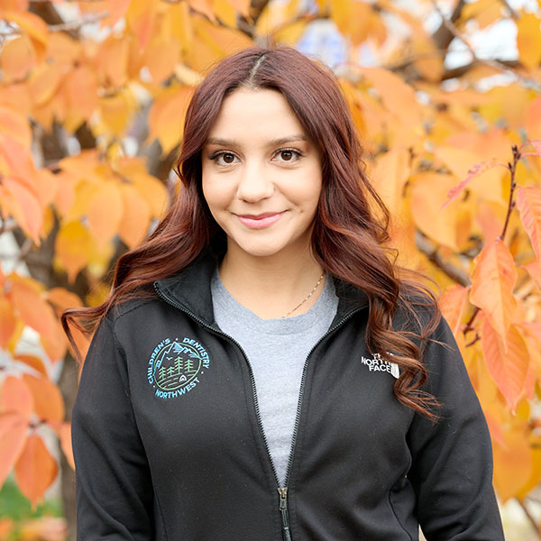 Young Woman Smiling By Green Wall