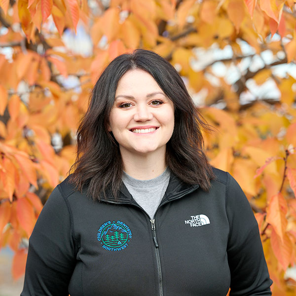 Young Woman Smiling By Green Wall